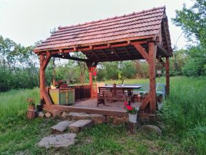 einen hölzernen Pavillon mit einem Picknicktisch auf einem Feld in der Unterkunft Big family Apartment in Breb's Cosy Barn in Breb