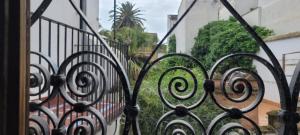 an iron gate with a view of a building at Palacio de los Angulo casa histórica en el centro de Córdoba in Córdoba