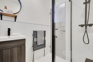 a bathroom with a shower and a sink at Apartment 1 Castle Lane in Bournemouth