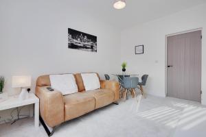 a living room with a couch and a table at Apartment 1 Castle Lane in Bournemouth