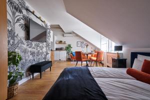 a bedroom with a bed and a dining room at Animal Planet by STN in Budapest
