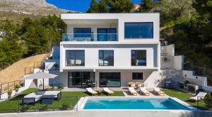 an aerial view of a house with a swimming pool at Villa Sunset Split overviewing Split and Podstrana bay in Strožanac