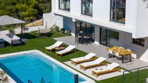 an aerial view of a house with a swimming pool at Villa Sunset Split overviewing Split and Podstrana bay in Strožanac