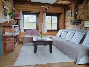 a living room with a couch and a table at Big family Apartment in Breb's Cosy Barn in Breb