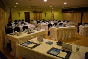 a room filled with tables and chairs with white table linens at Mara Serena Safari Lodge in Lolgorien