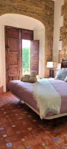 a bedroom with a large bed with a window at Palacio de los Angulo casa histórica en el centro de Córdoba in Córdoba