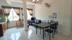 a kitchen and living room with a table and chairs at Smile Hub Kandy in Kandy