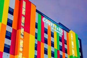 un edificio de color arco iris con una señal en él en Courtyard by Marriott Santiago Airport, en Santiago