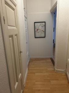 a hallway with a picture of flowers on the wall at Metropolitan Haven in Stockholm City! 911 in Stockholm