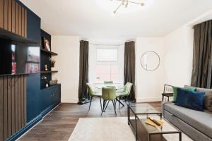 a living room with a table and a couch at Garmoyle Road Flat 2 in Liverpool