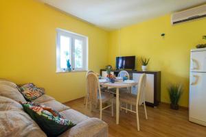 a living room with a table and a couch at Diamond Sea - Vacation House with Private Parking and a Big Terrace over the Sea in Dubrovnik