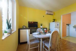 a dining room with a table and chairs and a refrigerator at Diamond Sea - Vacation House with Private Parking and a Big Terrace over the Sea in Dubrovnik +20 photos