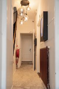 a hallway with a white door and a ceiling with lights at Hotel Kap City Centre in Amsterdam