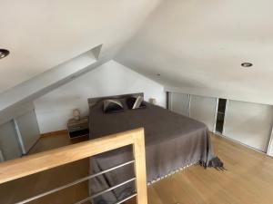 a bedroom with a bed in a attic at Le Relais des Chevaliers " Le Four à Pains " in Cordes-sur-Ciel +40 photos