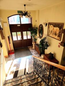 a hallway with a door with a horse picture on the wall at Hotel Aslan in Tarnowskie Góry