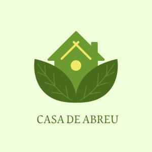 a green logo with a house on a leaf at Albergue Casa de Abreu in Redondela