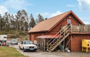 a red barn with a car parked in front of it at Awesome Apartment In Ljungskile With Wifi in Ljungskile