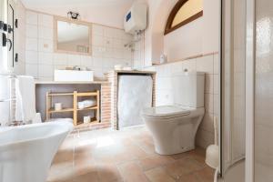 a bathroom with a toilet and a sink and a tub at Wish Apartment - Catania Centro Storico in Catania +81 photos