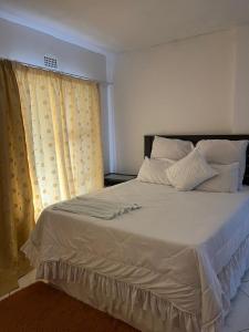 Postel nebo postele na pokoji v ubytování Sunset Guesthouse - Mthatha