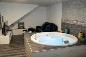 a large bath tub in a living room at Bulles Emotions in Arbois