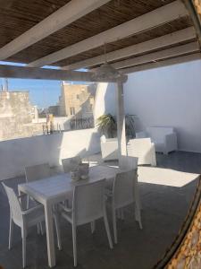 a white table and chairs on a patio at Attico Belvedere in Gallipoli
