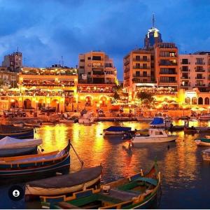 a group of boats in a harbor at night at Seaview Serenity 3-Bedroom Apt view over Valletta Harbour in Sliema