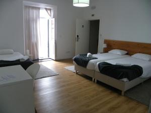 Postel nebo postele na pokoji v ubytování Lagoa Hostel & Suites