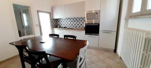 a kitchen with a wooden table and chairs in it at Dimora Panoramica in Alberobello