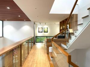 a hallway of a house with wooden floors and a staircase at M&M Homestay in Hue