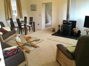 a living room with a couch and a fireplace at Cottage in Ayr