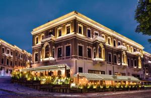 a large building with lights in front of it at King Suites Beşiktaş in Istanbul