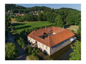 an aerial view of a building with a red roof at at the Haus Marck moated castle in Tecklenburg