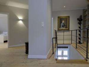 a room with a staircase and a painting on the wall at at the Haus Marck moated castle in Tecklenburg