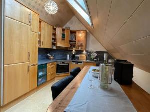 a kitchen with a table with a wine glass on it at Holiday apartment Kromer in Jechtingen