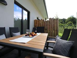 un tavolo in legno con un bicchiere di vino sopra di Villa Ostseekind a Neuhaus