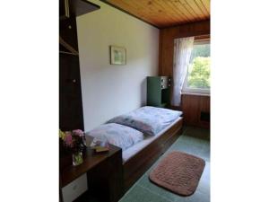 a bedroom with a bed with a desk and a window at 1 Siefertshof Comfortable holiday residence 
