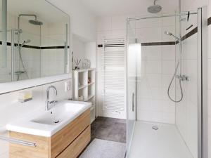 a white bathroom with a sink and a shower at Eifel Oasis Comfortable holiday residence in Monschau +22 photos
