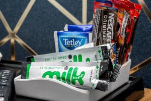 a pile of toothpaste and toothbrushes on a table at Mentone Hotel in London