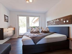 a bedroom with a large bed with shoes on it at Charly"s Sweet Modern retreat in Norderney