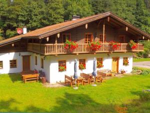 a house with chairs and umbrellas in front of it at 2 holiday guesthouse Posthof in Waldmünchen