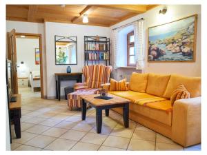 a living room with a couch and a table at 2 holiday guesthouse Posthof in Waldmünchen