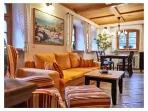 a living room with a couch and a table at 2 holiday guesthouse Posthof in Waldmünchen