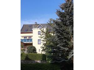 a large white building with solar panels on its roof at Farsighted modern retreat in Annaberg-Buchholz