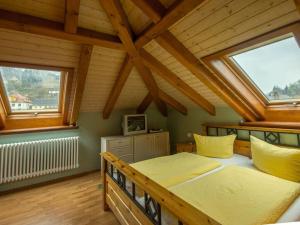 a bedroom with a bed and two windows at Ender DG Modern retreat in Sebnitz