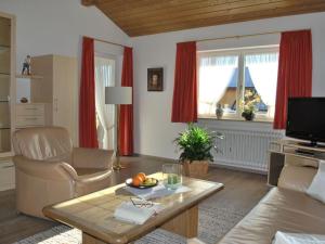 sala de estar con cortinas rojas y mesa en Haus Jörg Sosna Modern retreat en Bayersoien