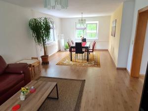 a living room with a couch and a table at Bräuer Modern retreat 