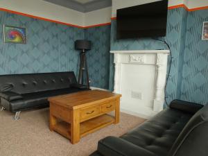 a living room with a couch and a table at Earthling 1, Apartment in Blackpool