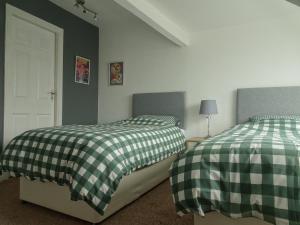 two beds sitting next to each other in a bedroom at Earthling 1, Apartment in Blackpool