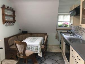 a small kitchen with a table and a sink at Haus Hiller Modern retreat in Brandenberg