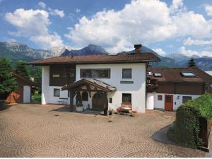 a large white house with a large courtyard at Holiday apartment in Bavaria in Schönau am Königssee